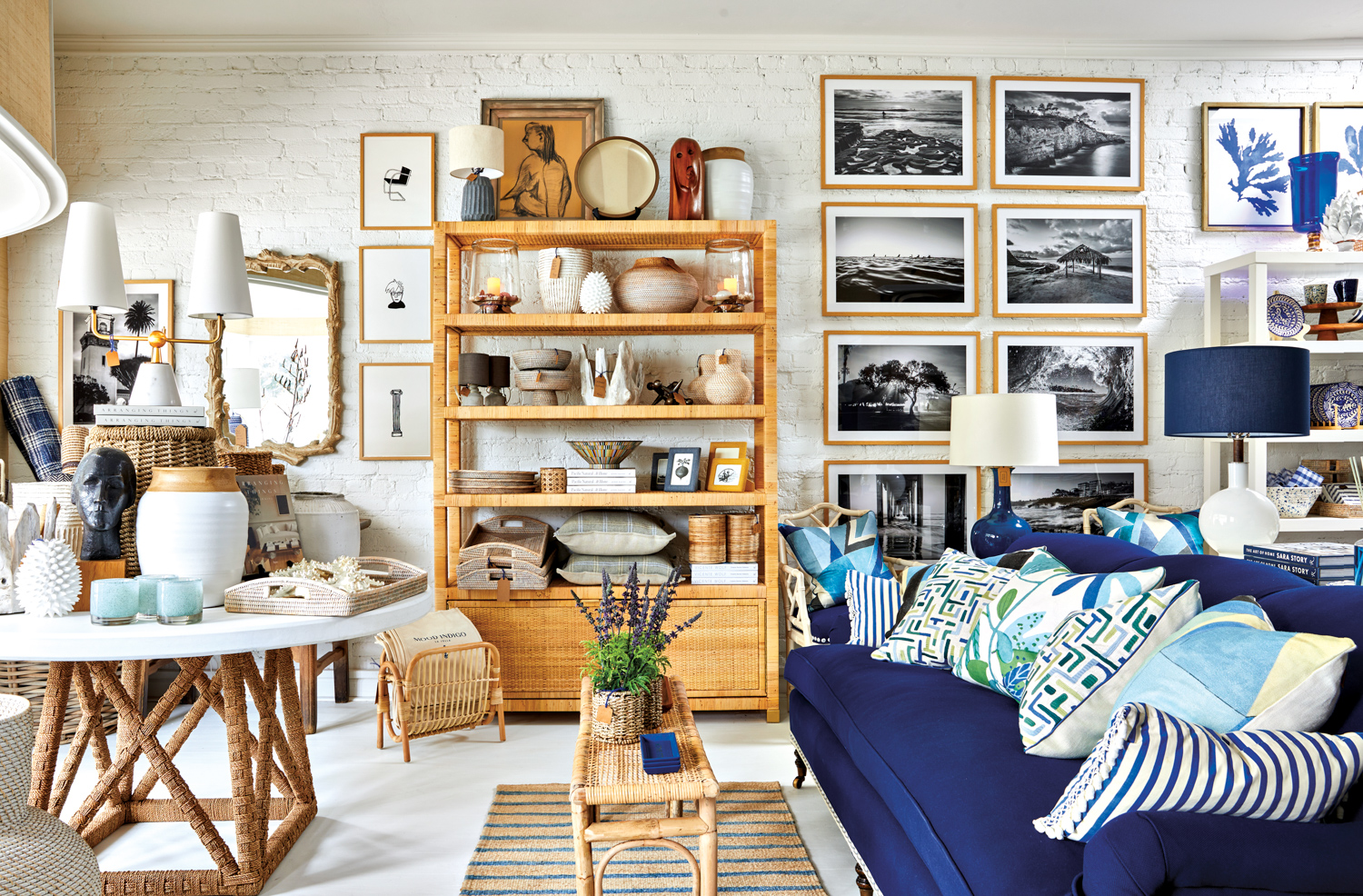 Mood Indigo with an indigo-colored sofa, rattan furniture and black-and-white photographs on the wall