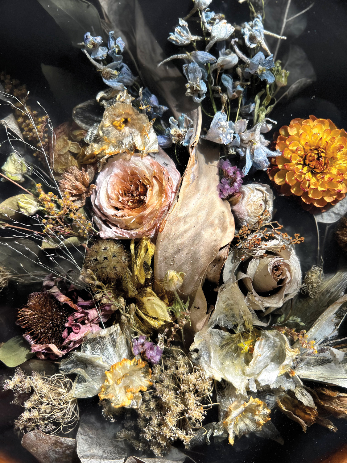 a dried bouquet set in epoxy against a black background