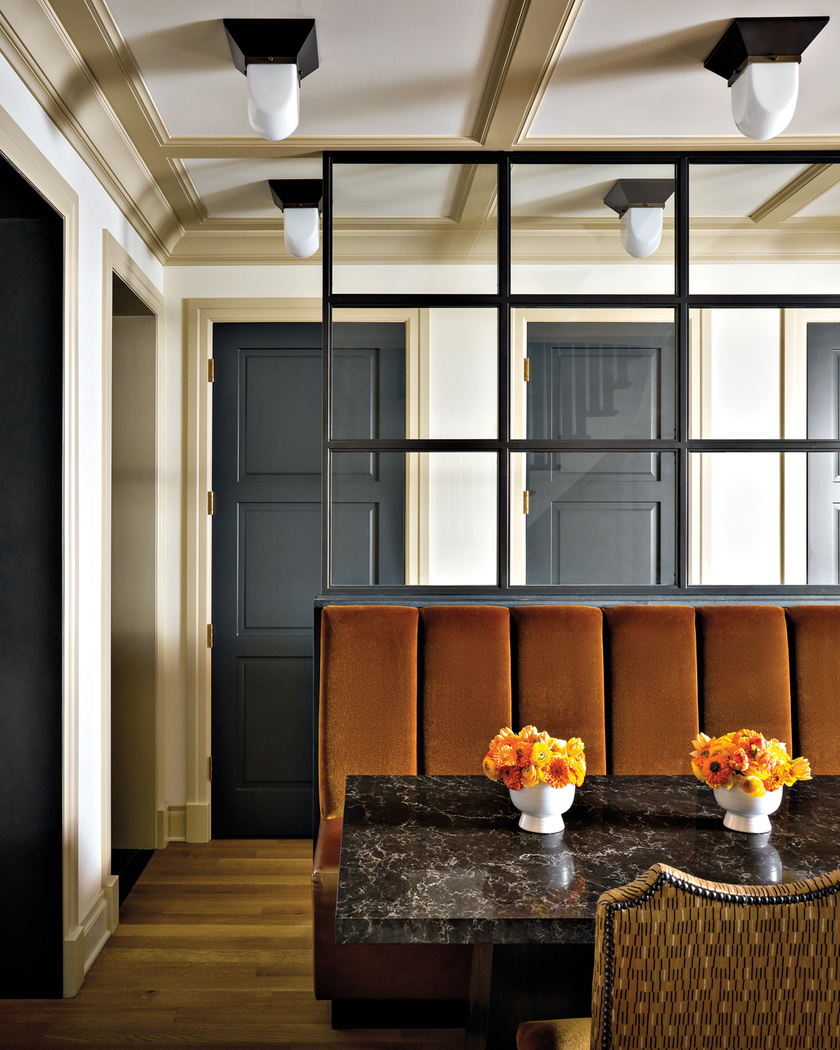 Dining space with velvet-backed banquette...