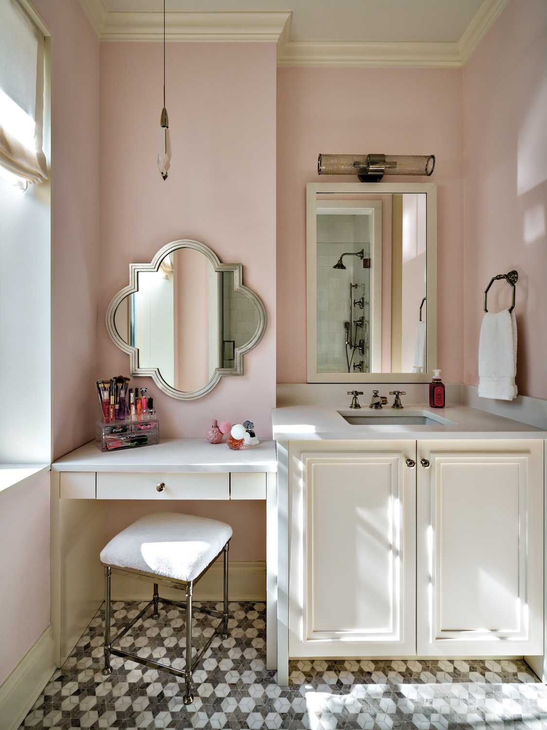 Pink bathroom with white vanity...