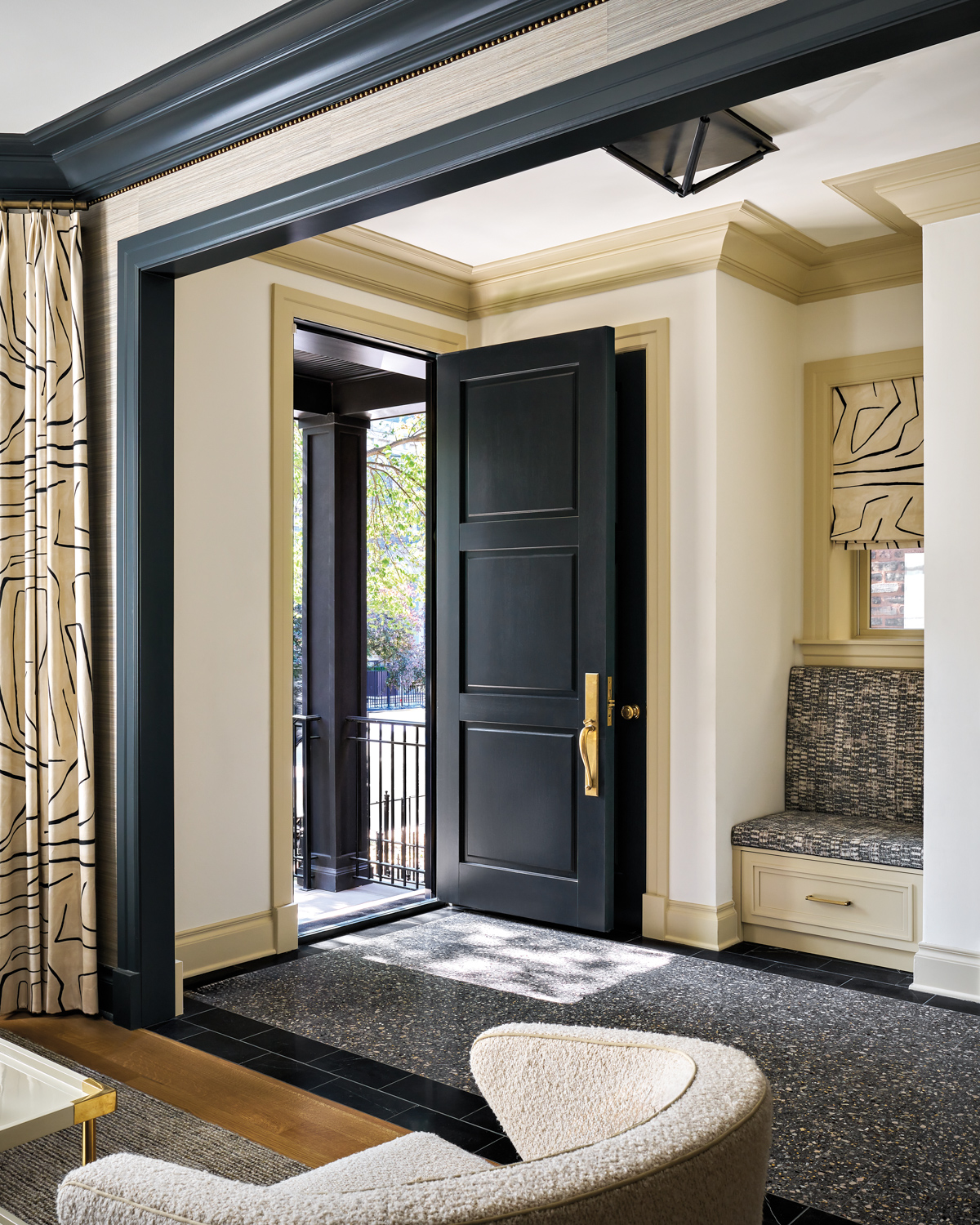 Black-white-and-tan entryway with a built-in...