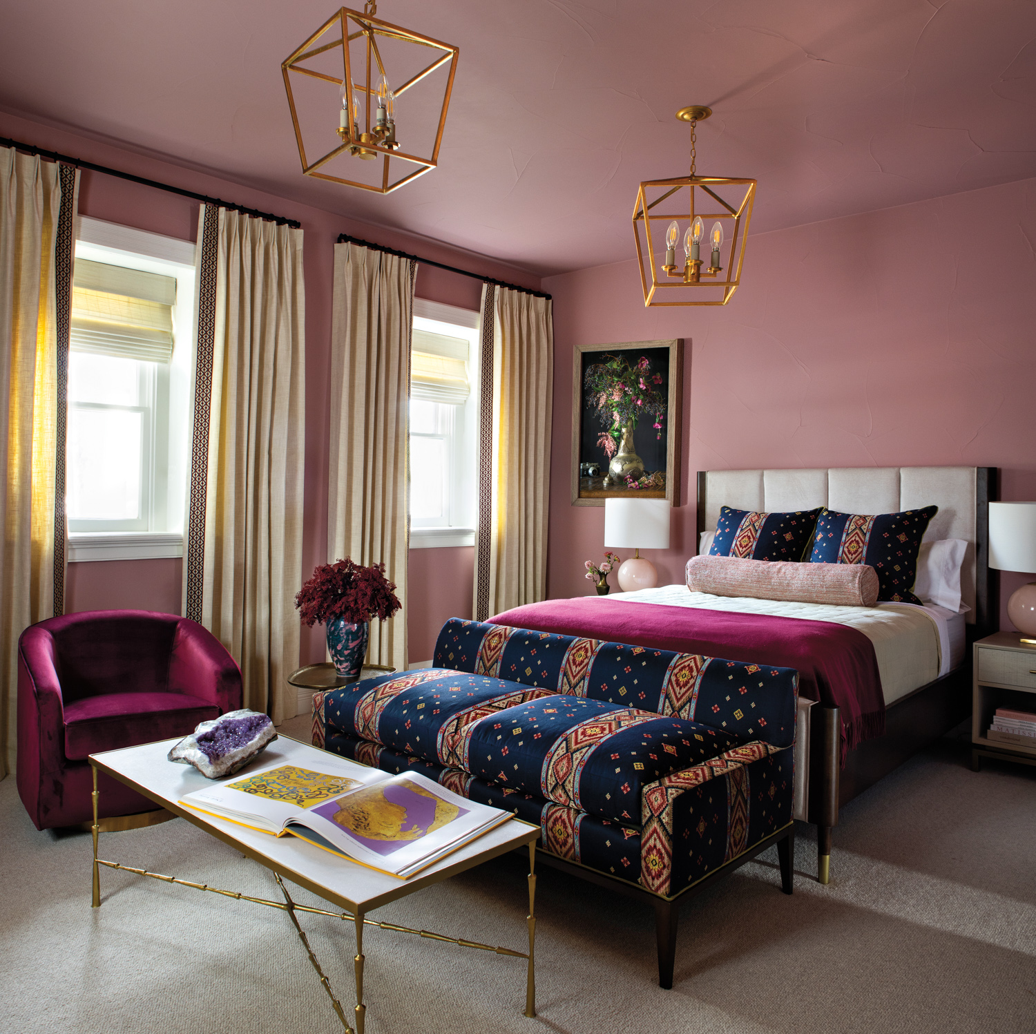 Pink bedroom with raspberry-colored armchair,...