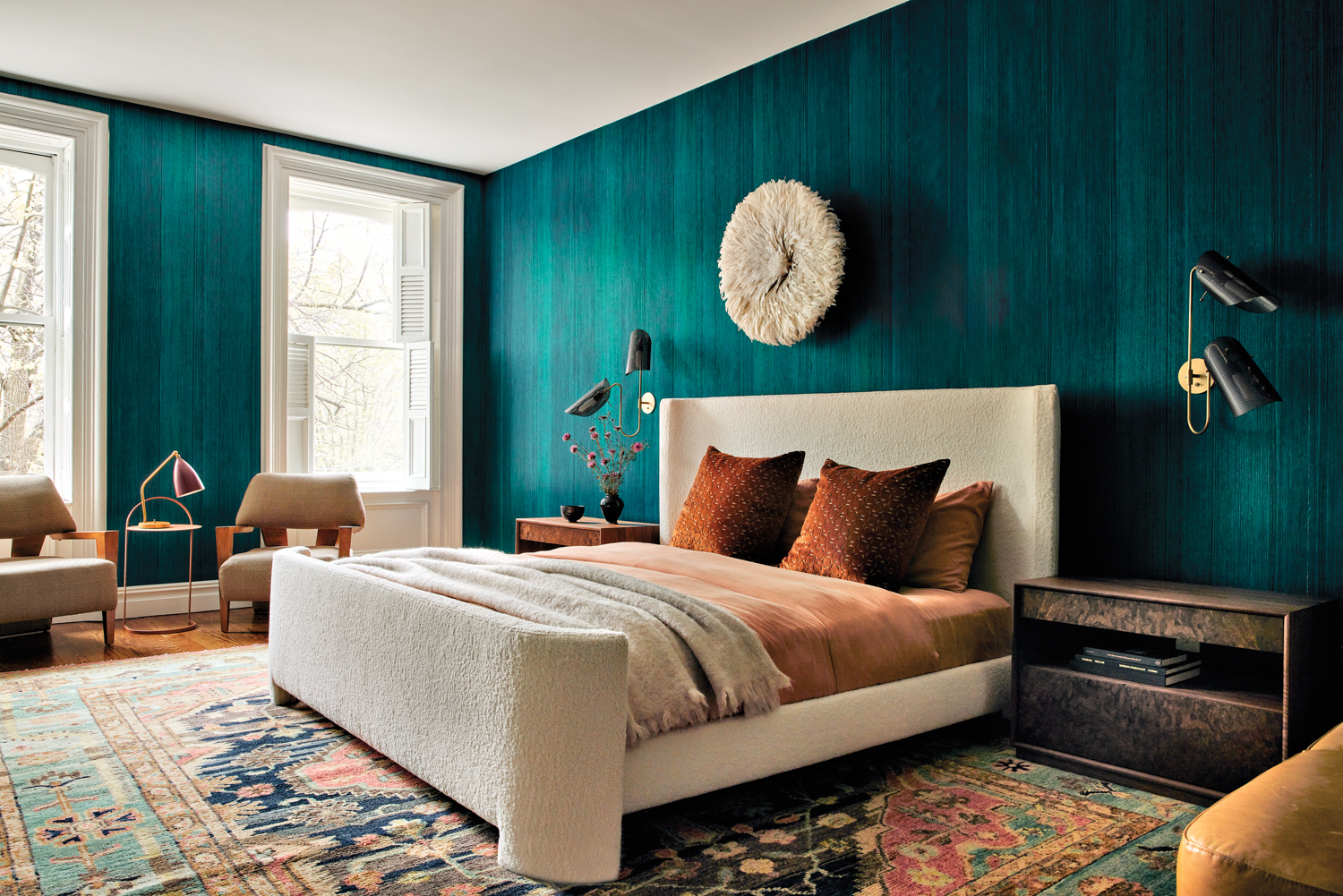 a teal-walled bedroom with a...