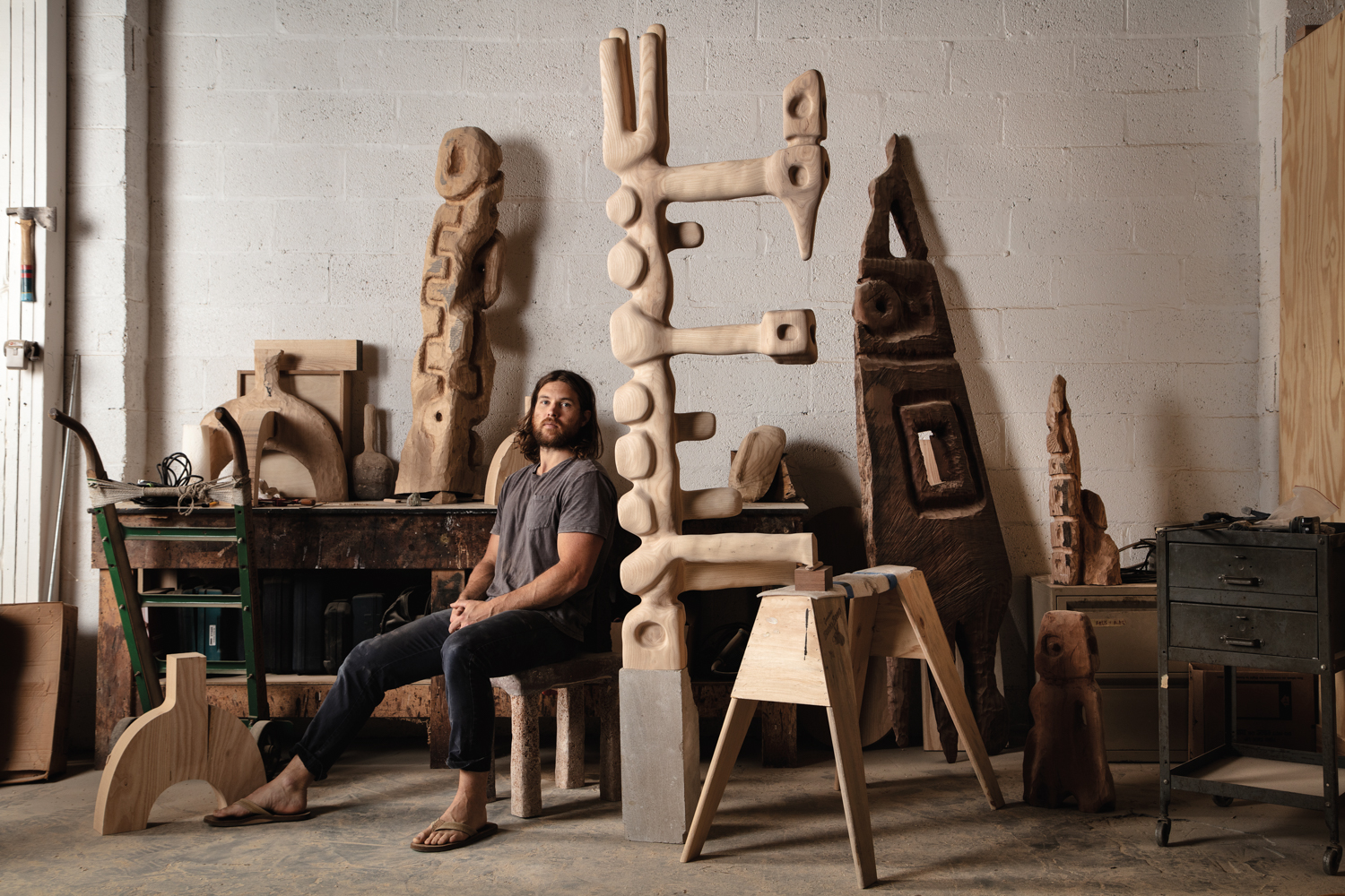 Sculptor Casey McCafferty in his studio surrounded by his work