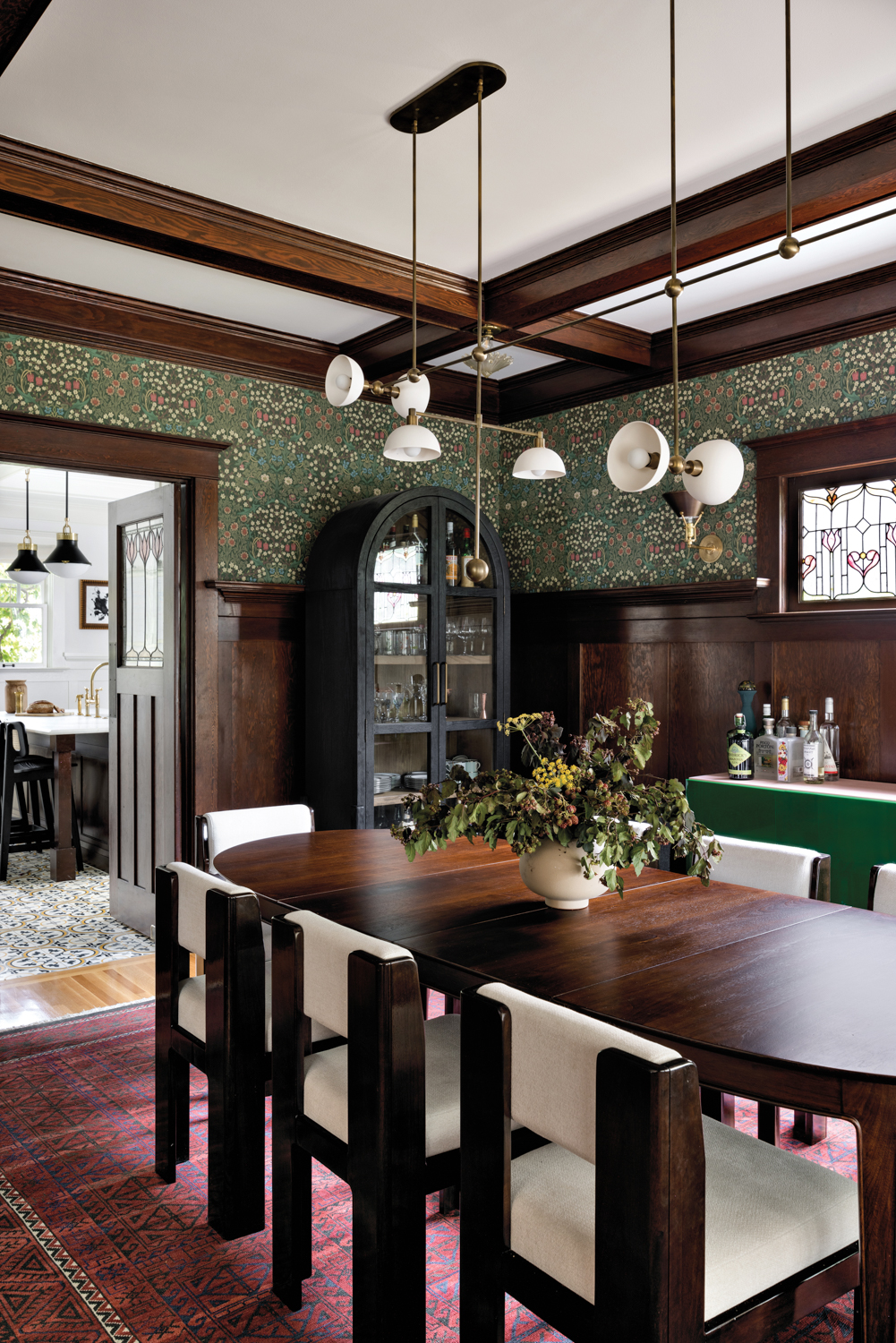 Dining room with green wallpaper,...