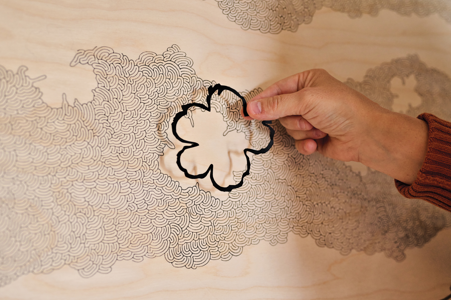 The artist uses hand-cut forms in her work.