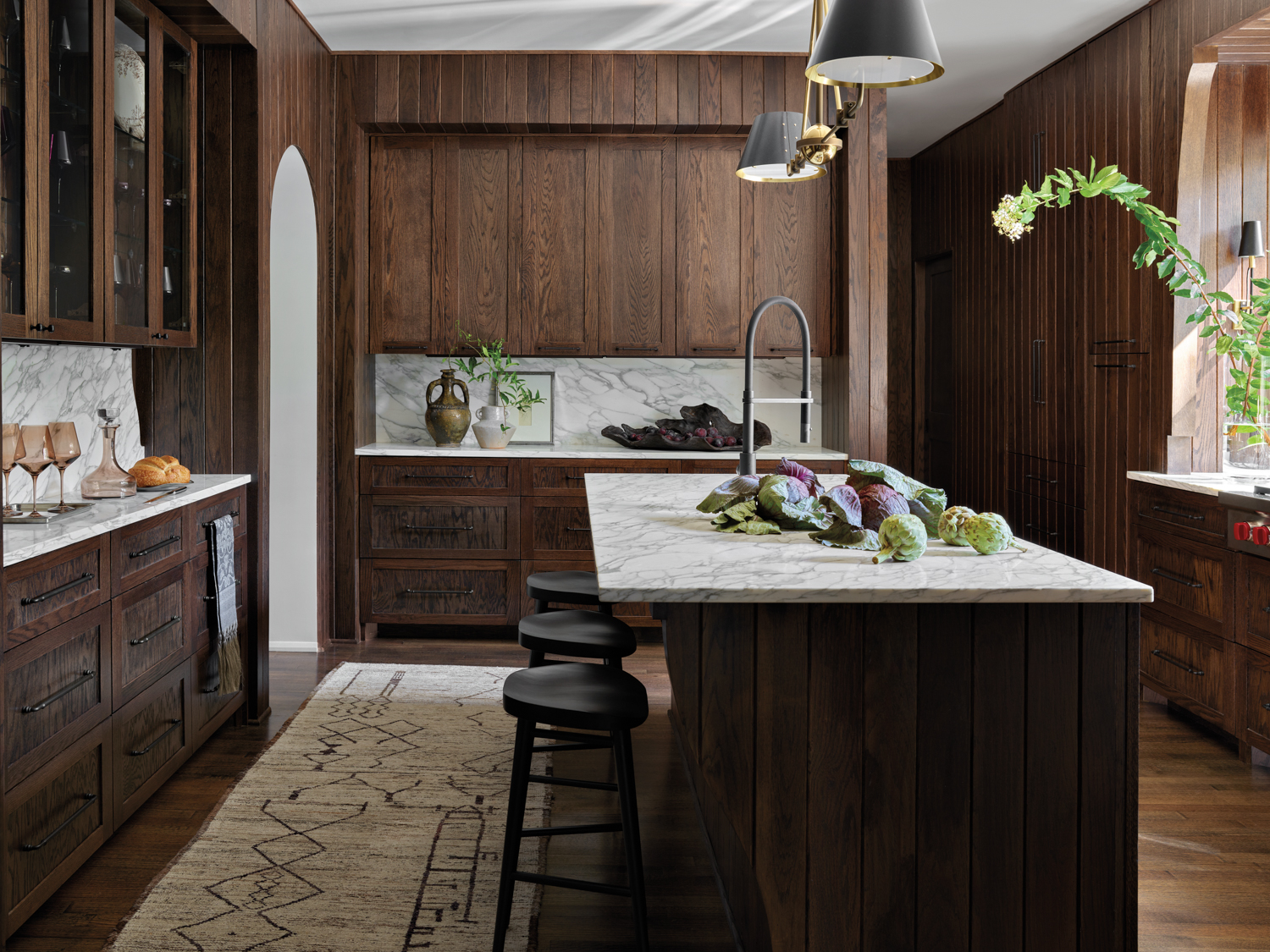 Kitchen with dark wood cabinetry,...