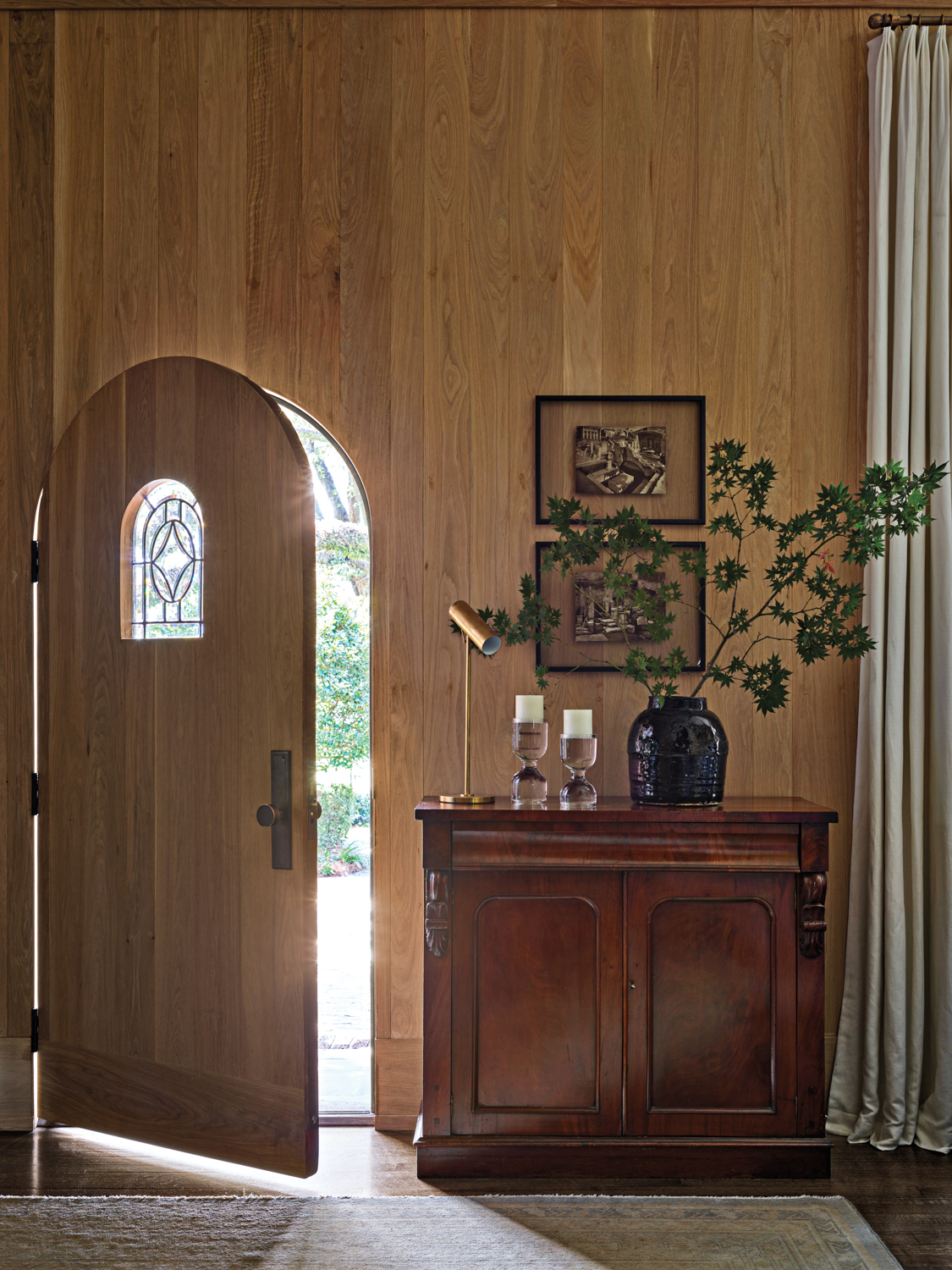 Living room with white-oak paneled...