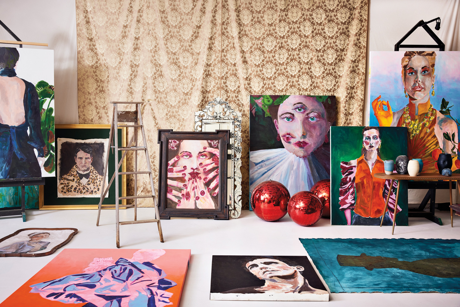 Multiple large artworks by Daniel Zimmerman, draped fabric and red disco balls
