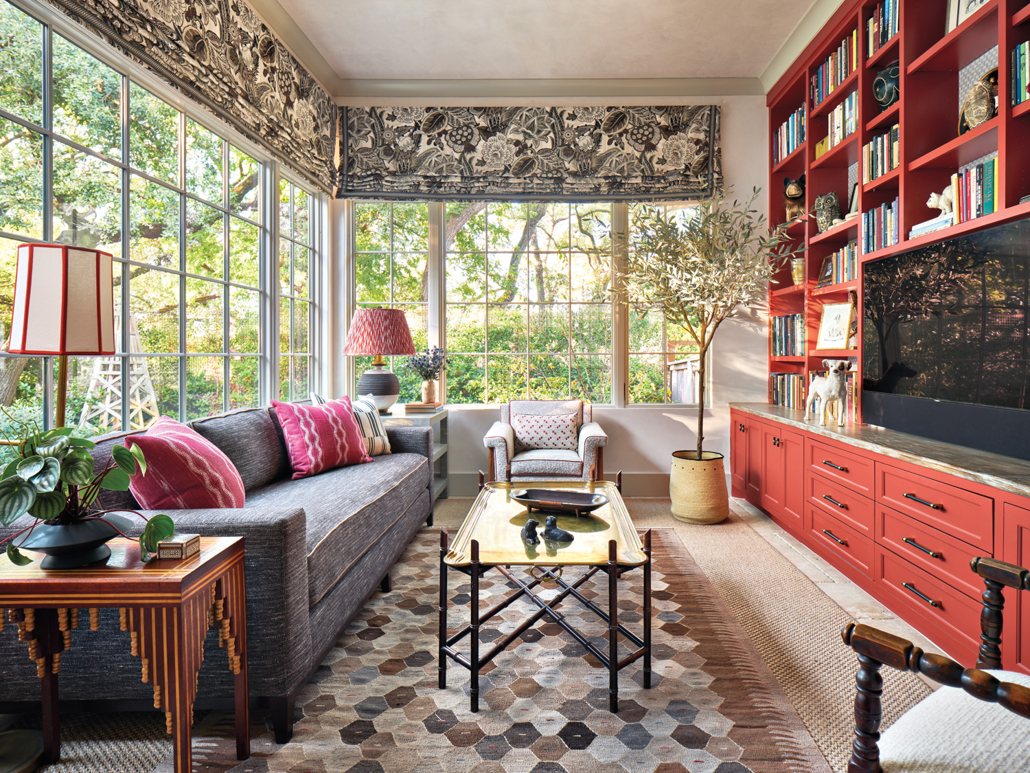 Sun room with red cabinetry,...