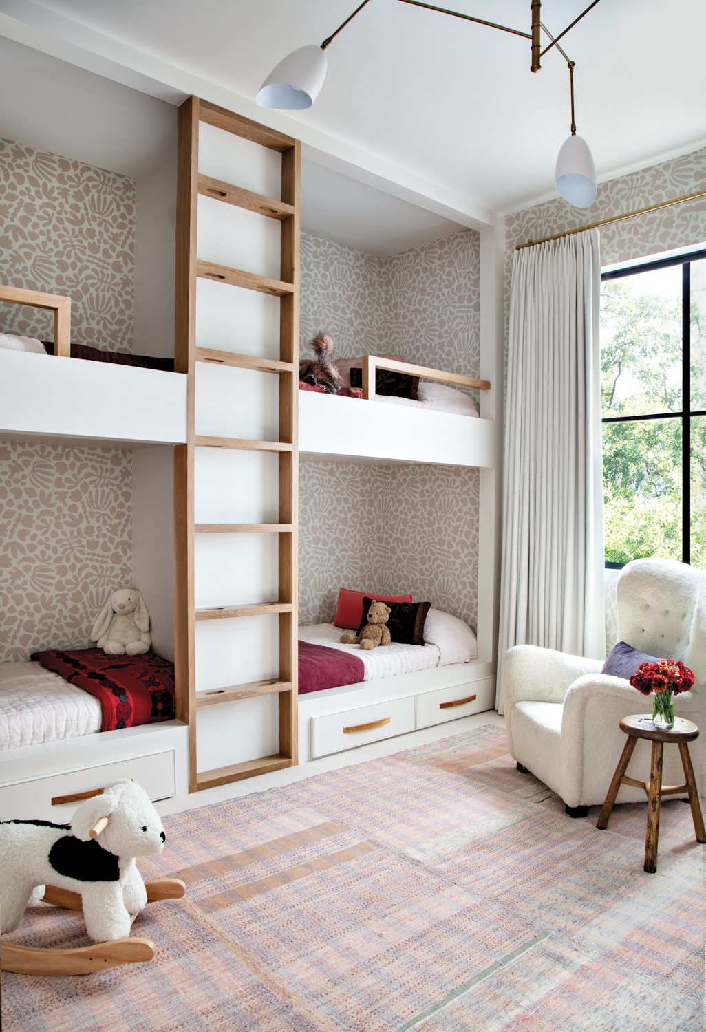 Light-filled bunk room with pink...