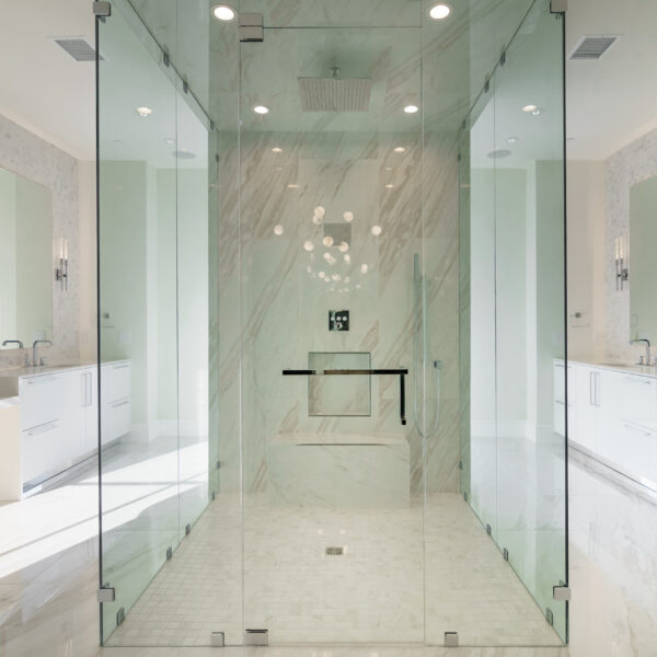 A spacious bathroom featuring a glass shower door.