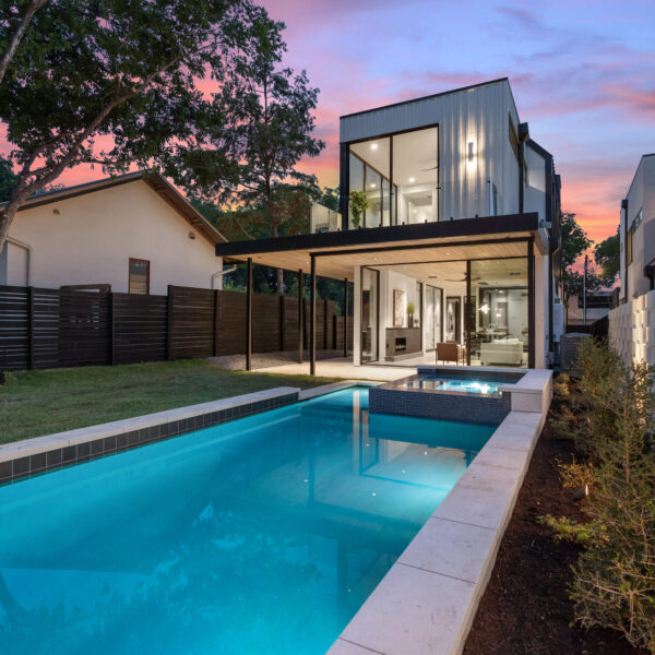 A contemporary house with a pool and deck, offering a perfect blend of style and relaxation.
