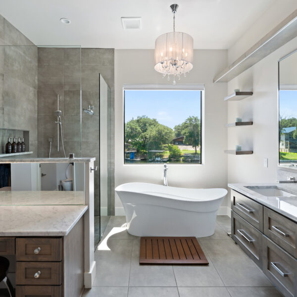 A spacious bathroom featuring a sizable tub and a sink.