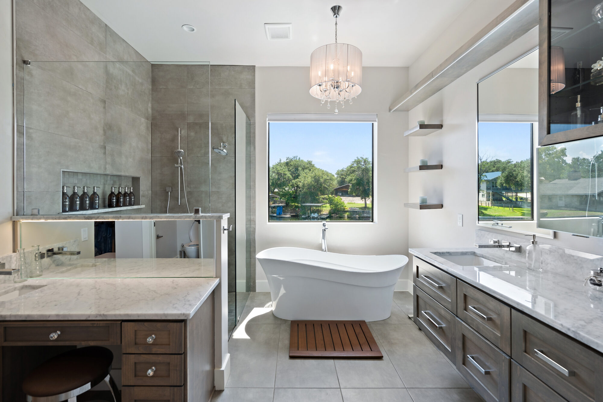 A spacious bathroom featuring a sizable tub and a sink.