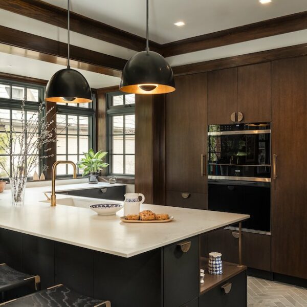 A contemporary kitchen featuring sleek dark cabinets contrasting elegantly with a luxurious marble countertop. The modern design incorporates stainless steel appliances and minimalist decor, creating a sophisticated culinary space.