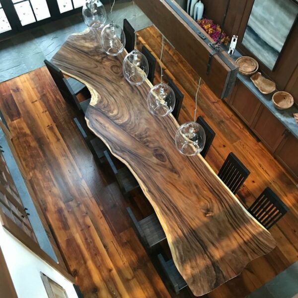 Live edge dining table with sophisticated lighting fixture.
