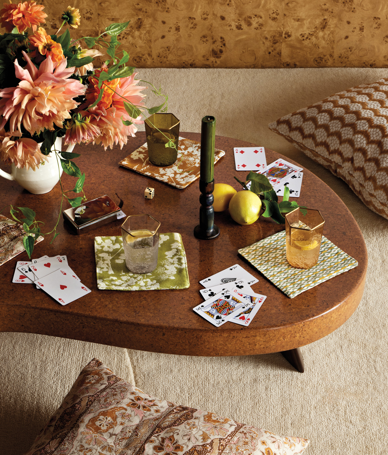 Playing cards atop a coffee table in a home with '70s accents and materials