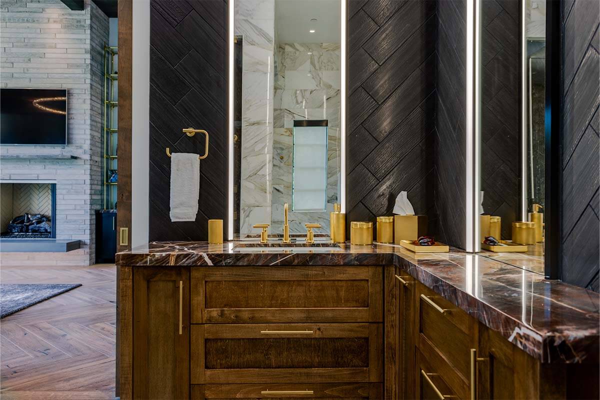 A bathroom with a marble countertop and a large mirror.