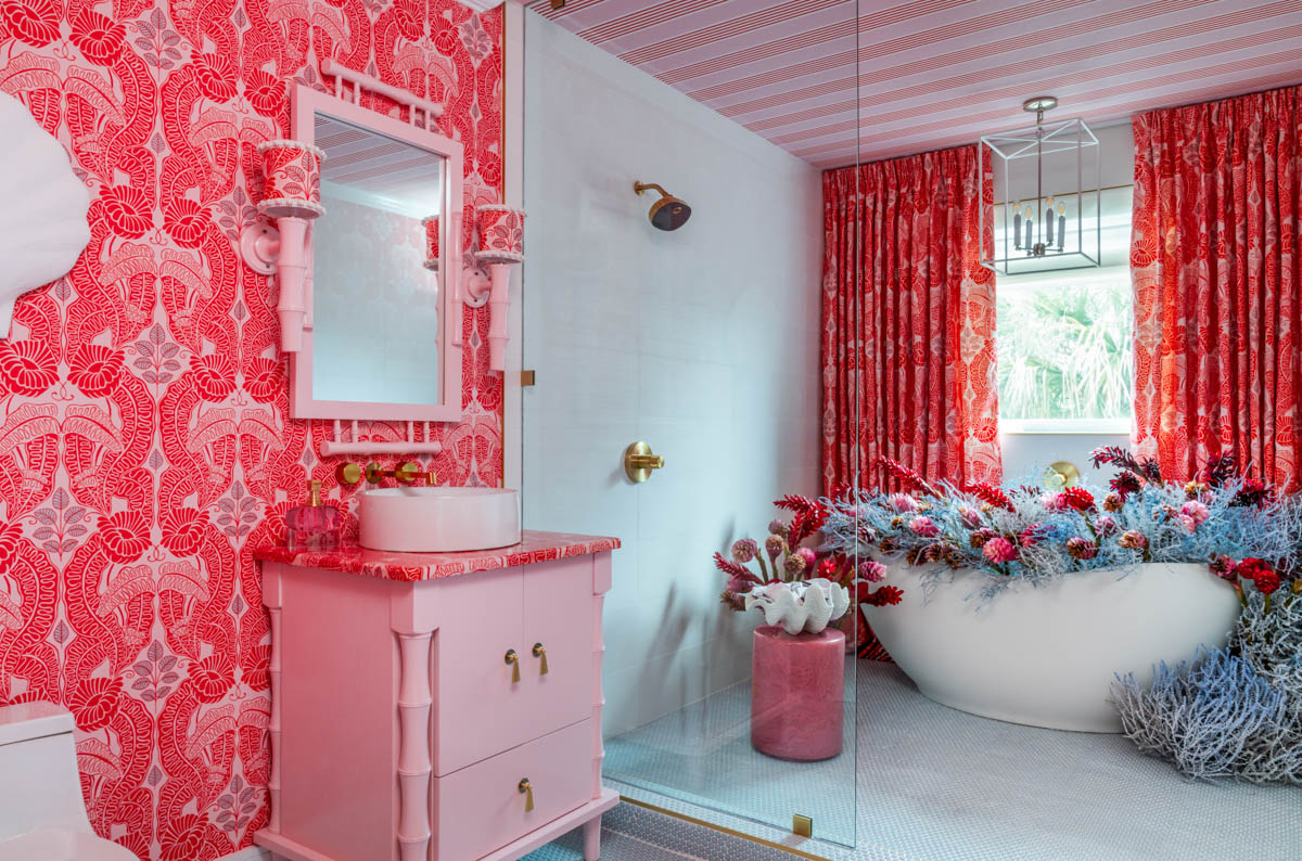 hot pink wallpapered bathroom with matching curtains and vanity