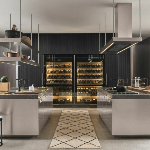 Sleek kitchen featuring wine fridge and bar in a spacious double island layout.