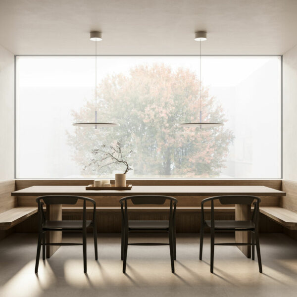 A well-lit dining room with a wooden table and comfortable chairs, inviting for a meal or gathering.