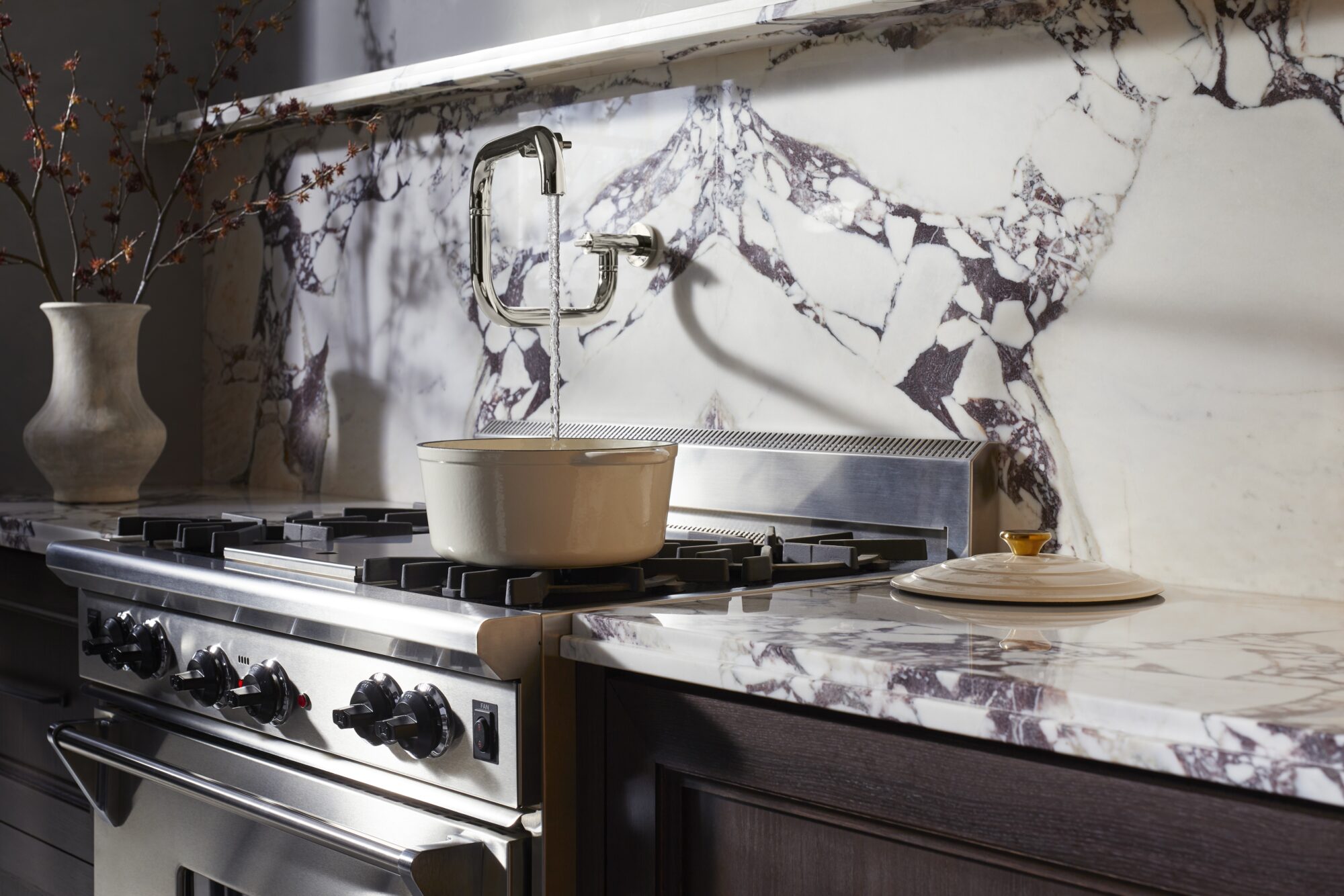 Kohler kitchen faucet against a marble backsplash