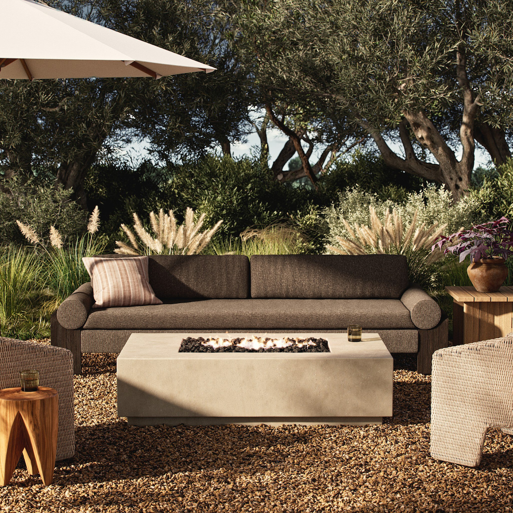 a patio with a fire pit and a couch