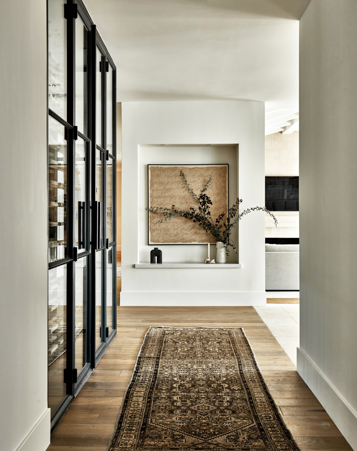 hallway with vintage black-and-tan rug,...
