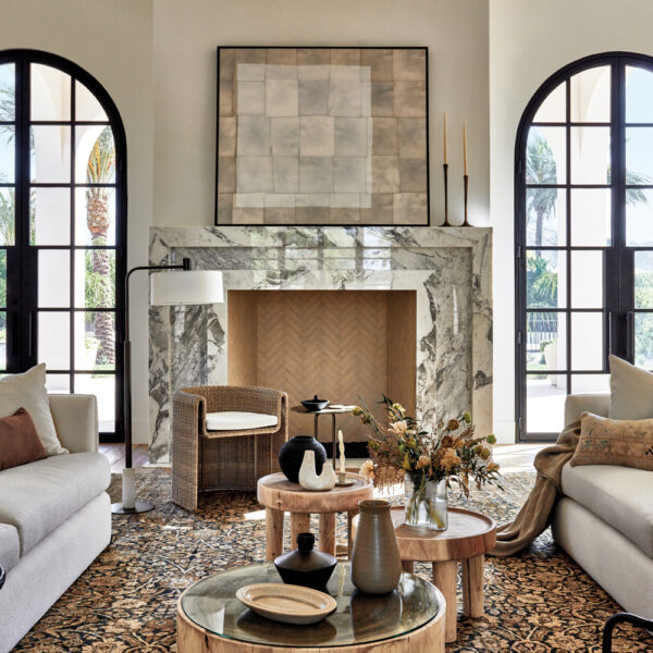 living room with twin white sofas, marble fireplace and steel-and-glass arched doors