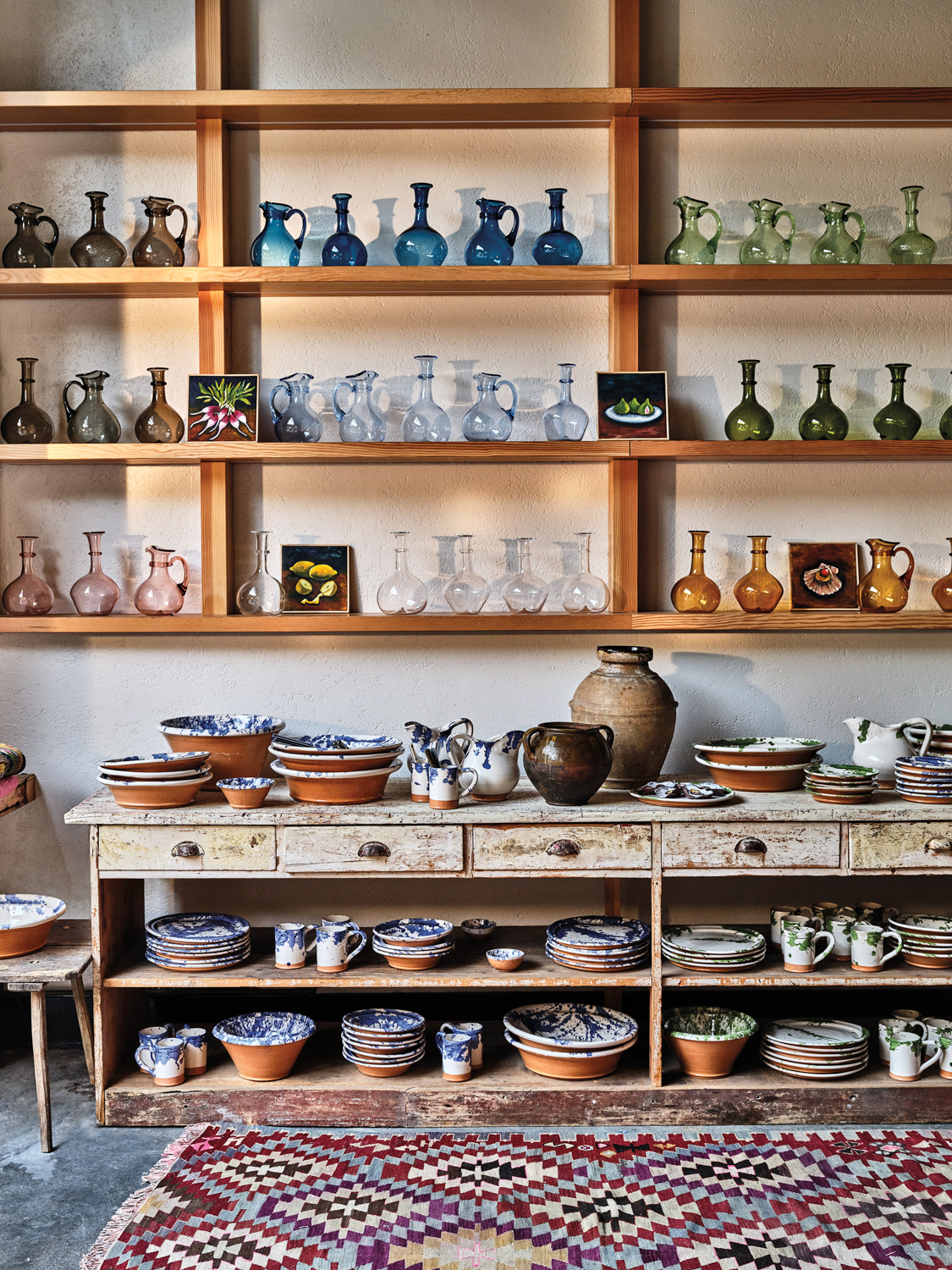 Shelves full of glassware and ceramics at il Buco Vita