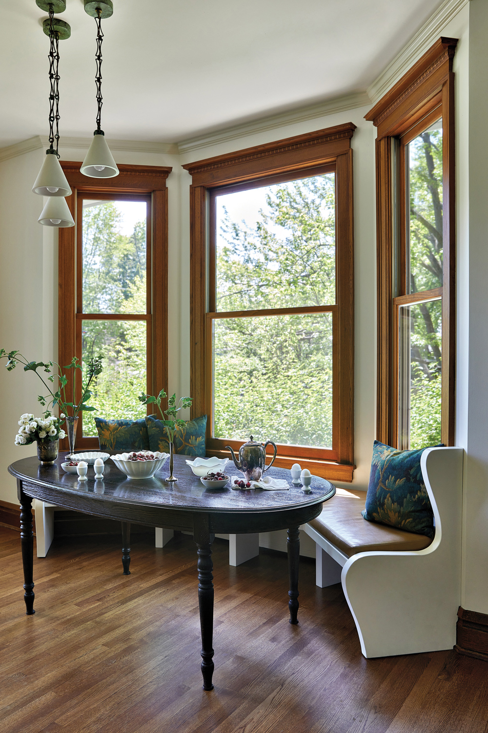 breakfast nook along wood-trimmed windows...