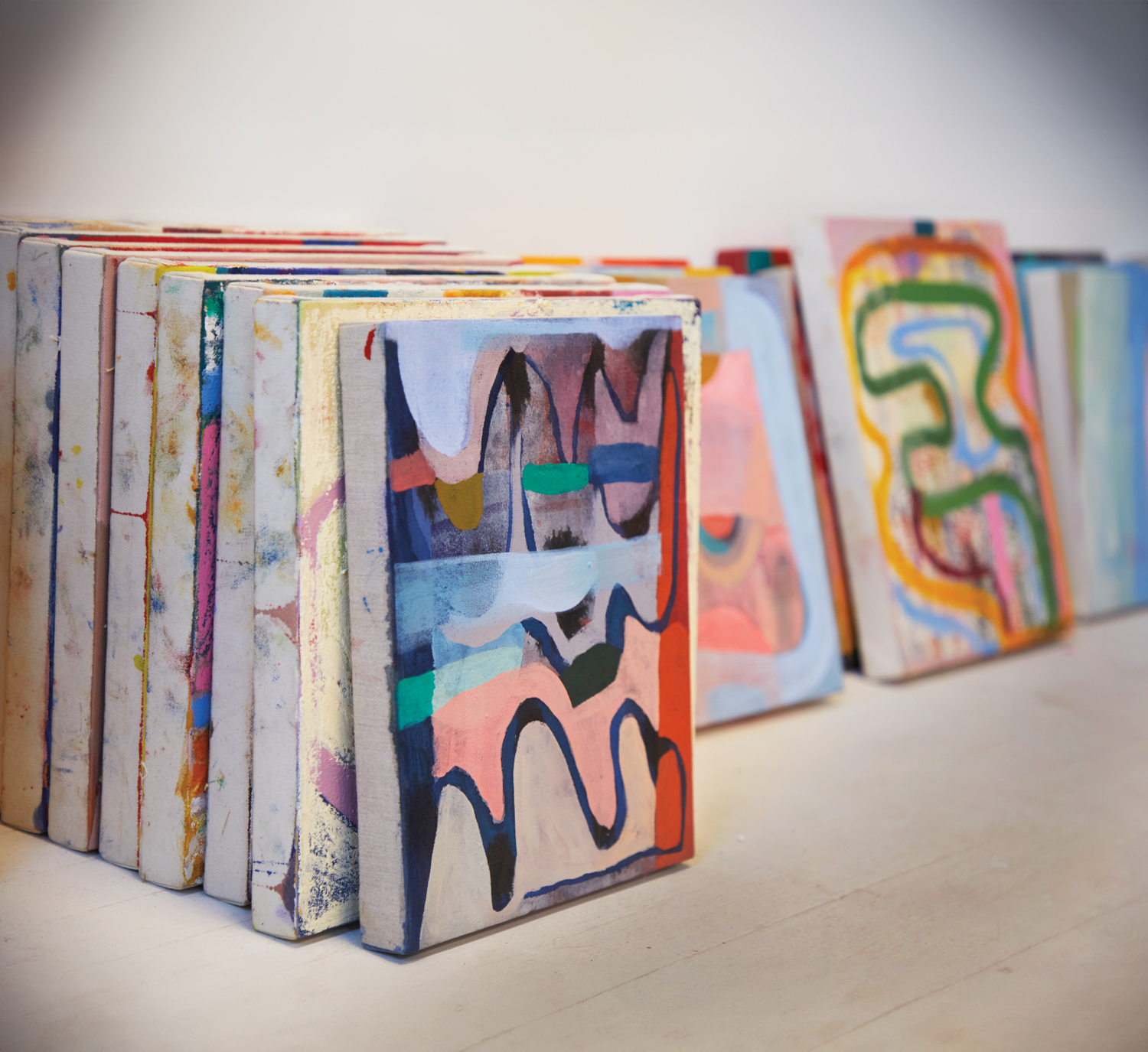 colorful paintings lined up in standing rows
