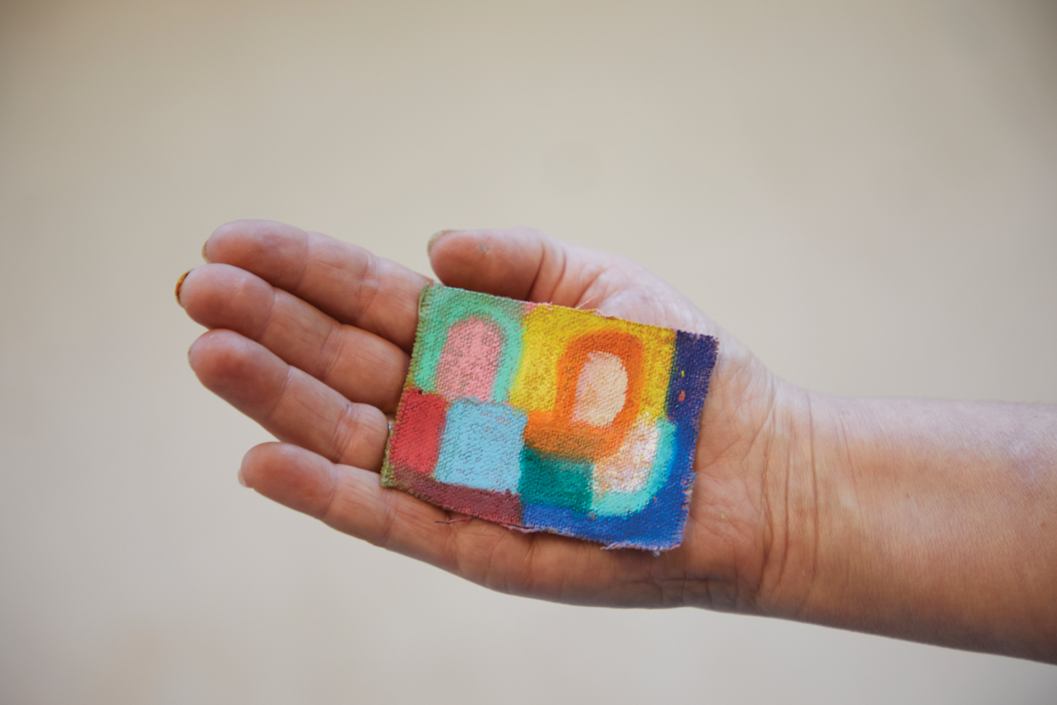 palm-size colorful painting held in someone's hand