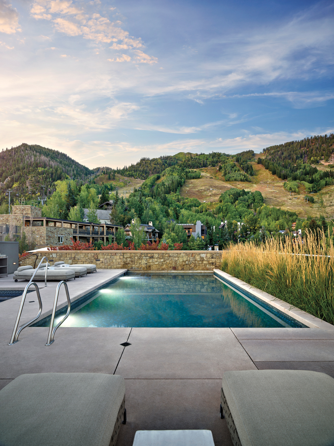 A pool with summer mountain views in Aspen.
