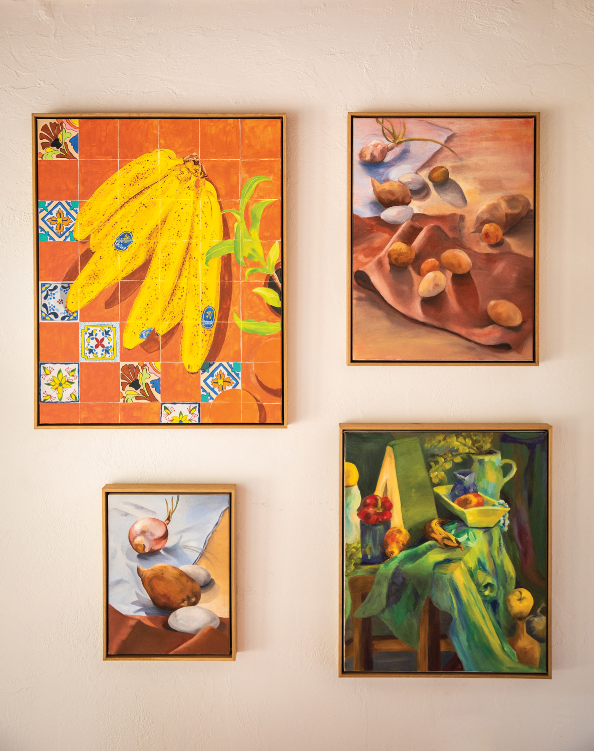 four oil paintings by Natalia Juncadella hanging on her studio wall
