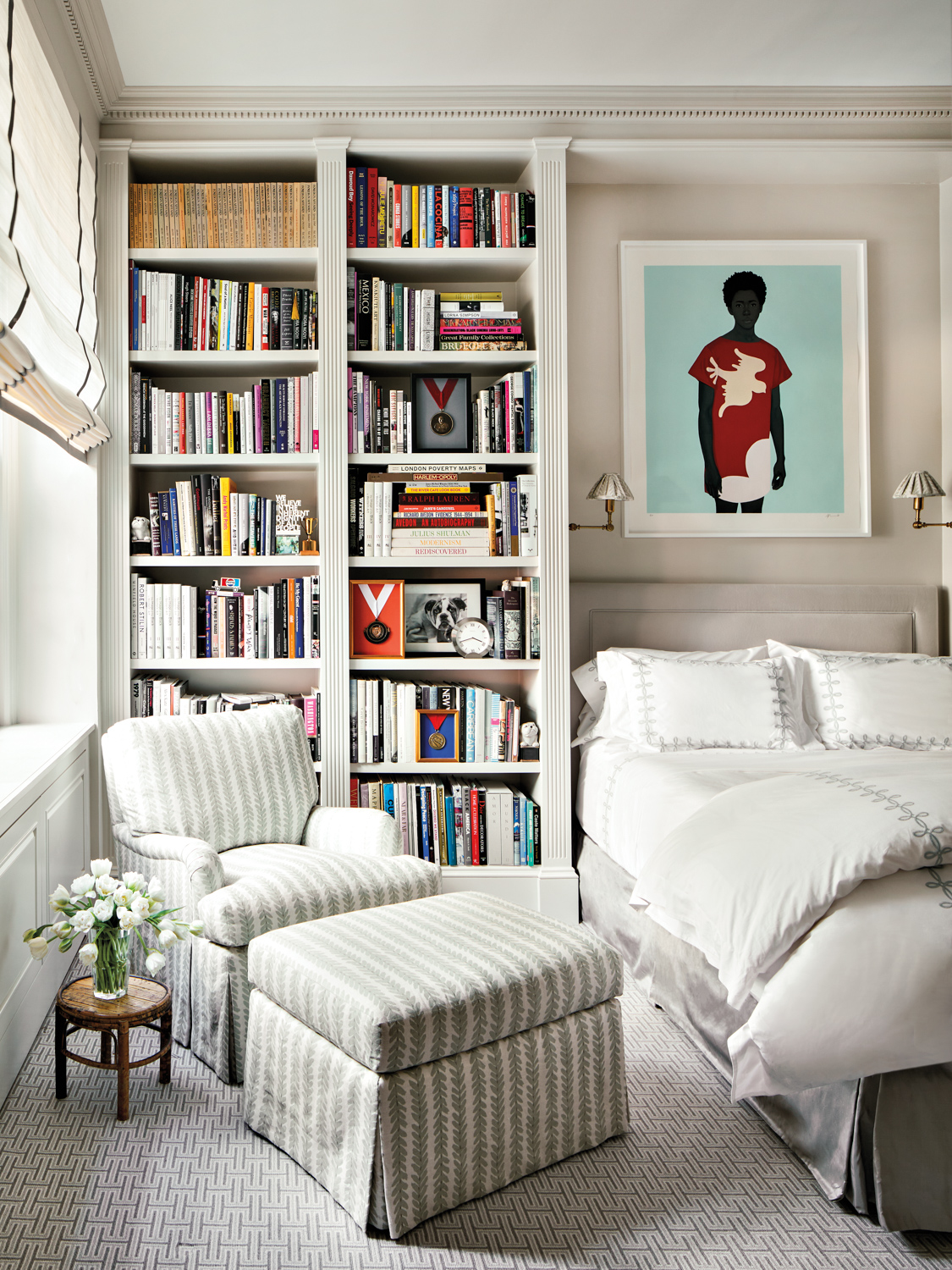 Bedroom with bookshelves and an...