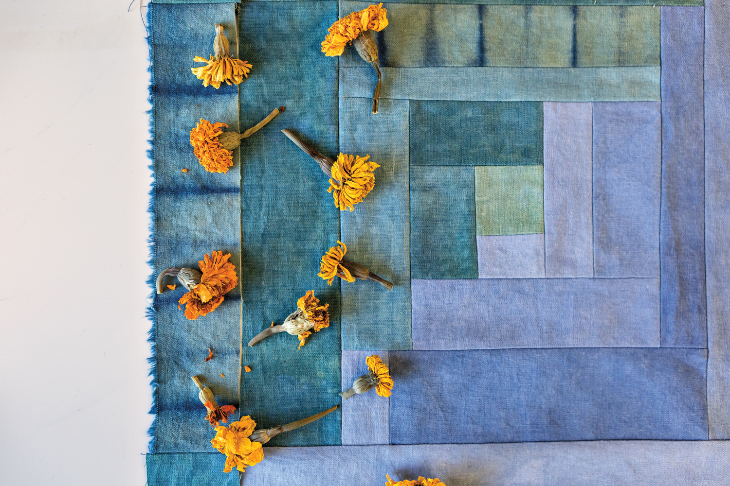 marigolds sit atop a quilted square