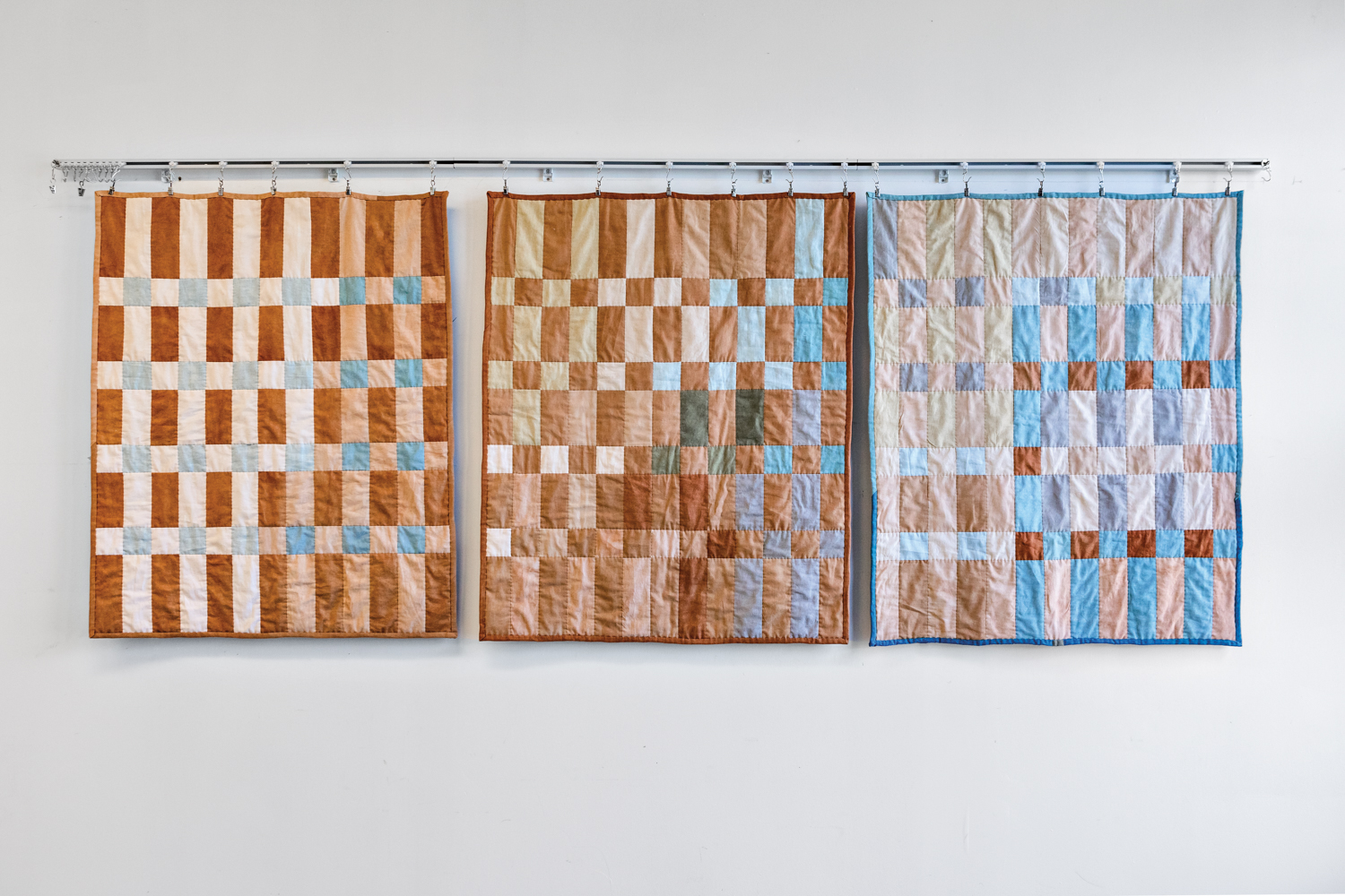 3 of Alison Charli Smith's quilts hanging on the wall
