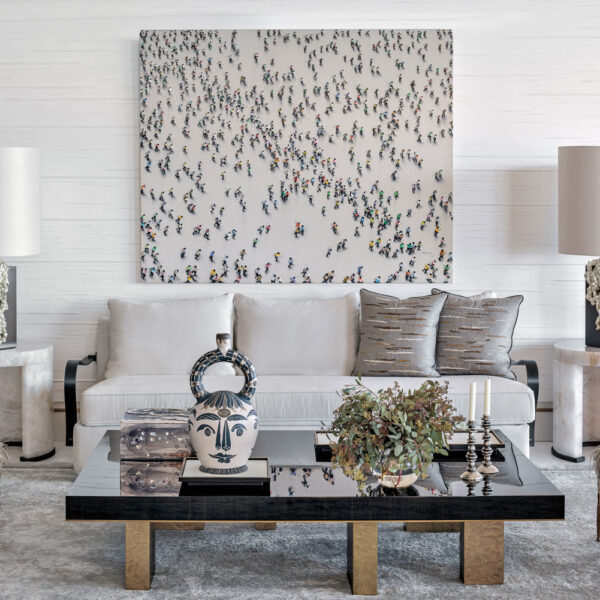 modern great room with large-scale artwork over white sofa and a rectangular coffee table