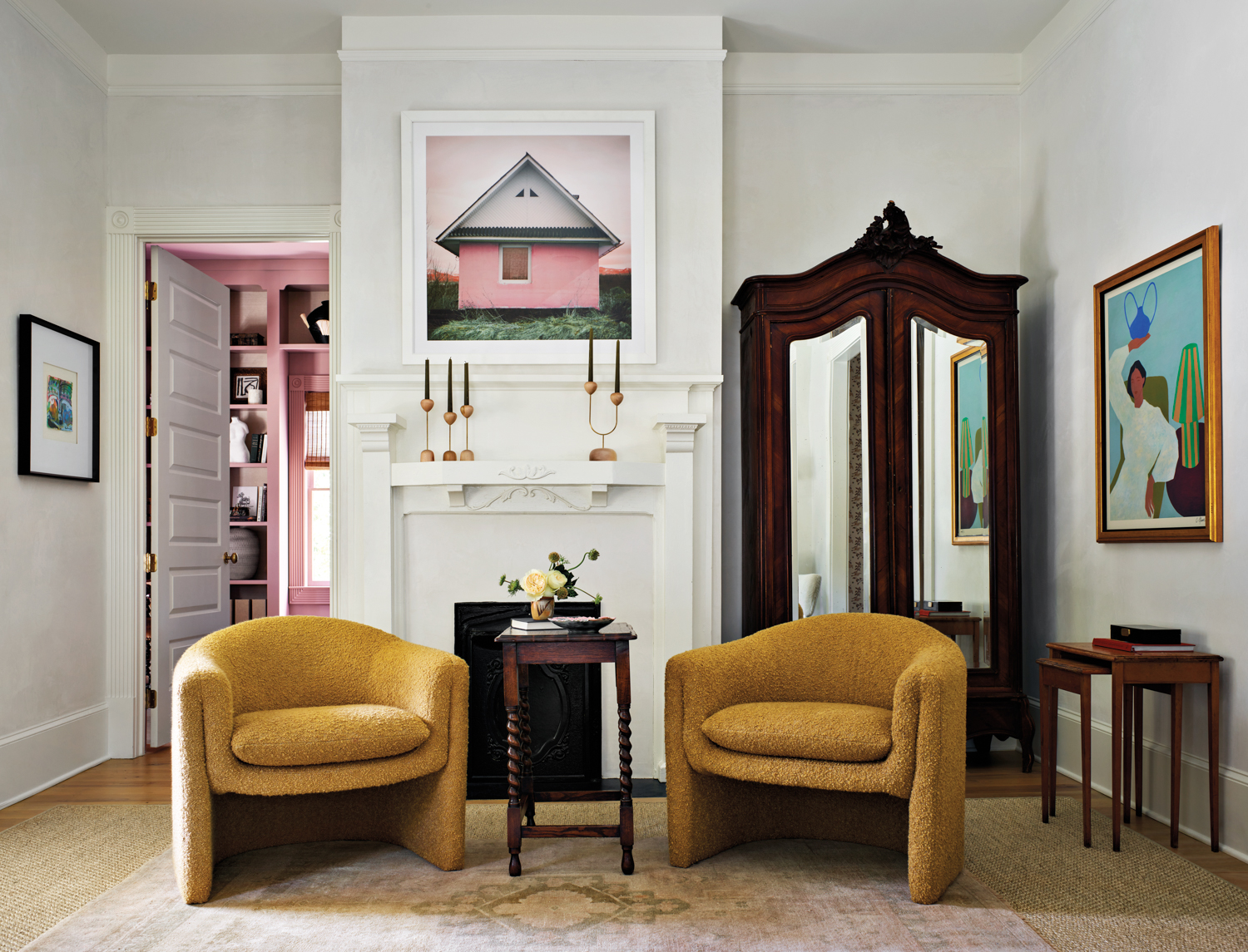Sitting room with ochre-colored armchairs,...