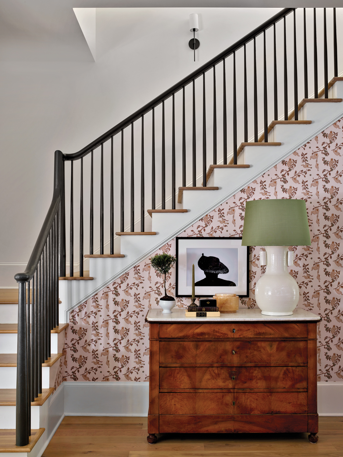 Staircase with pink floral wallpaper,...