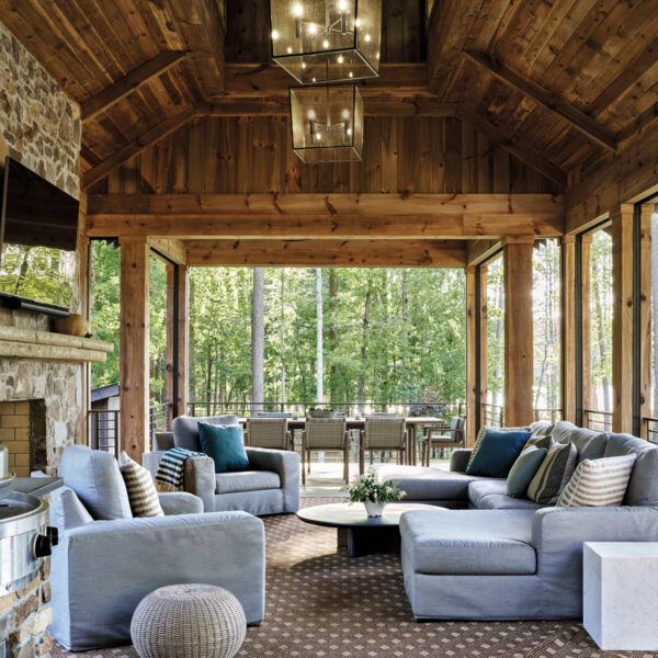 Covered porch with elaborate wood ceiling and slipcovered blue upholstery