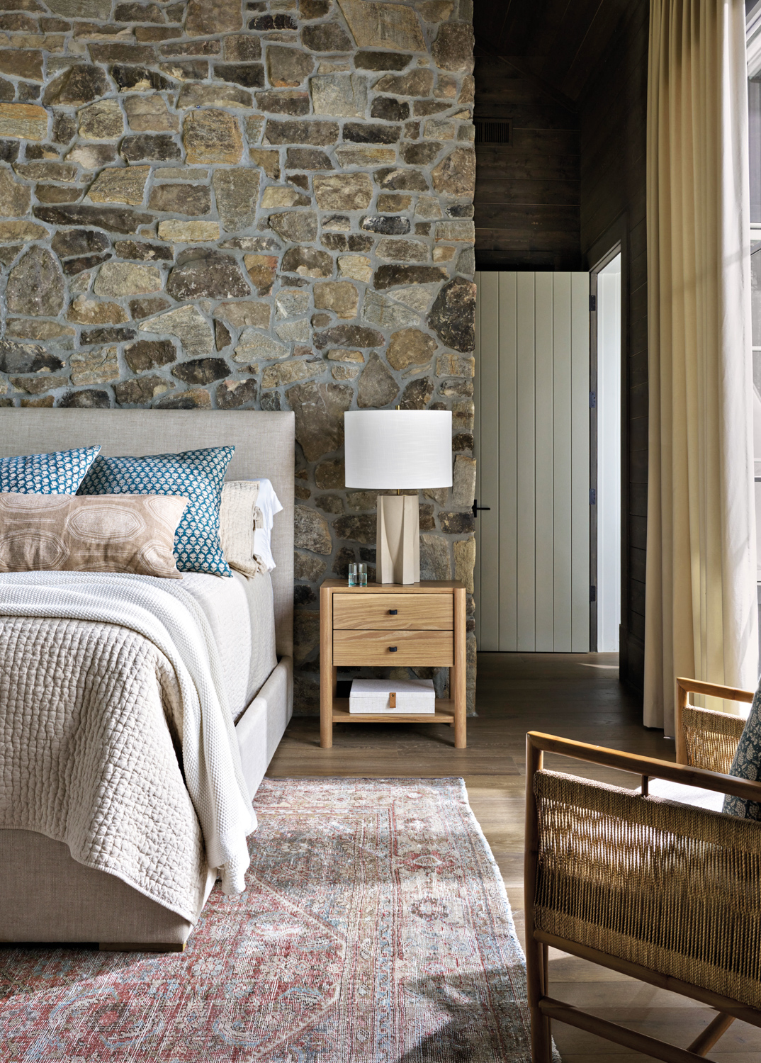 Bedroom with stacked stone wall,...