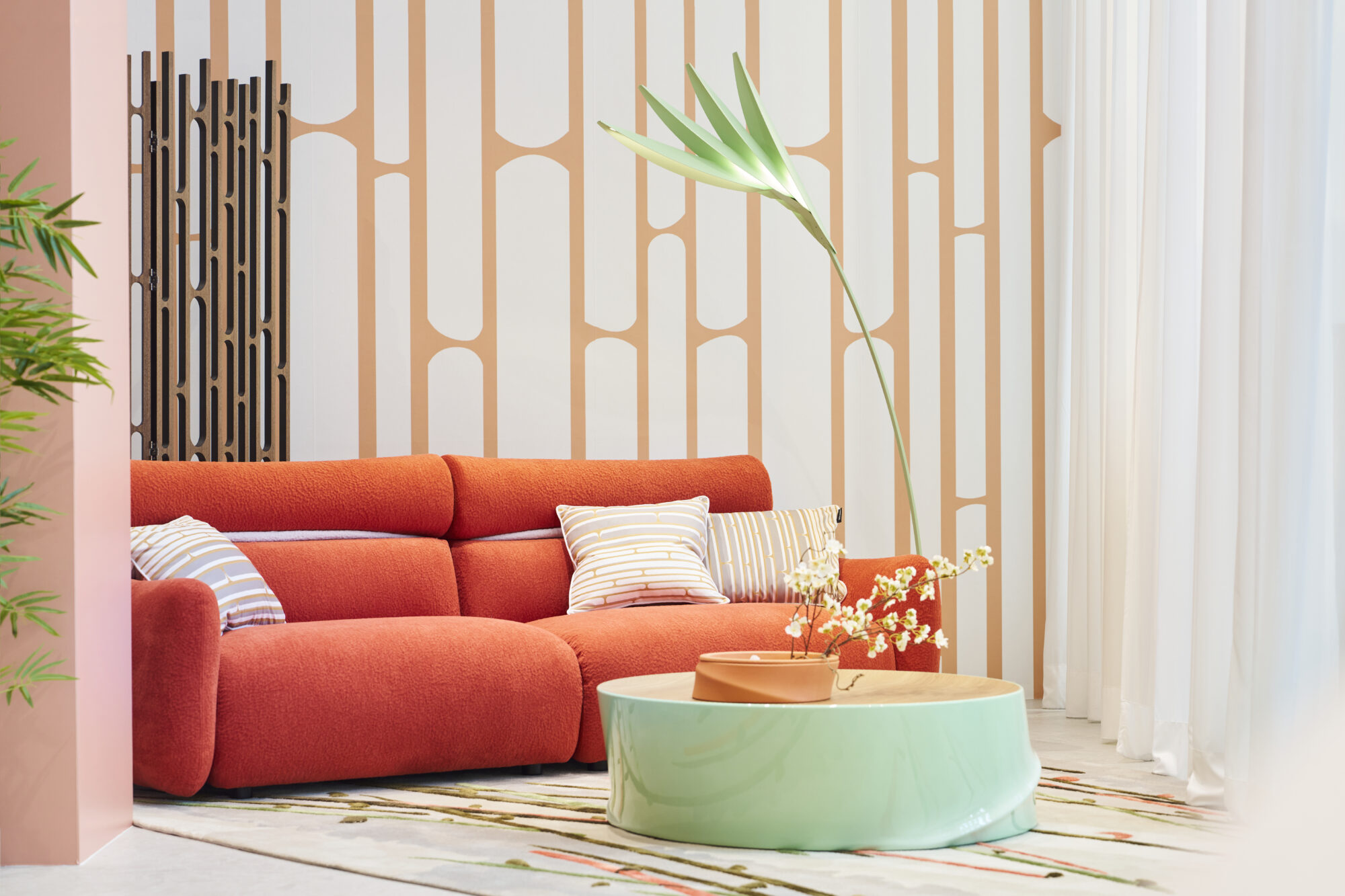orange sofa and green coffee table vignette on display at Milan Design Week 2024 