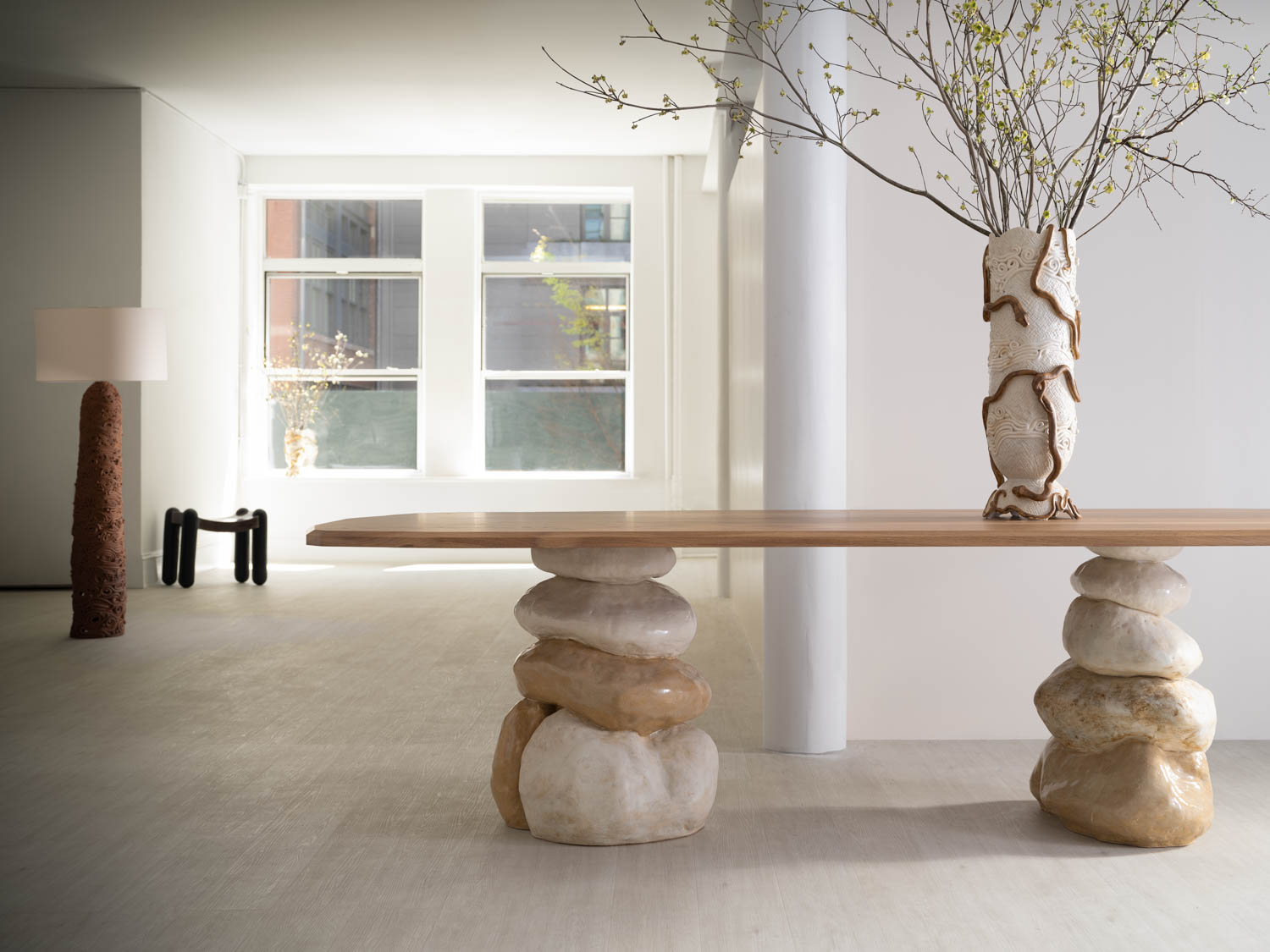 a stone table with a ceramic planter on top of it