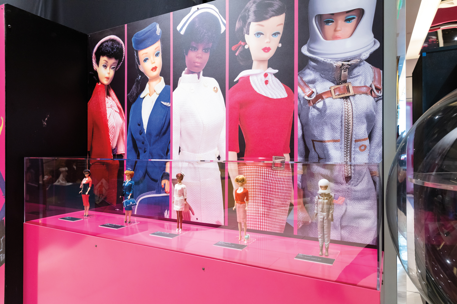 an exhibition poster of vintage Barbie dolls