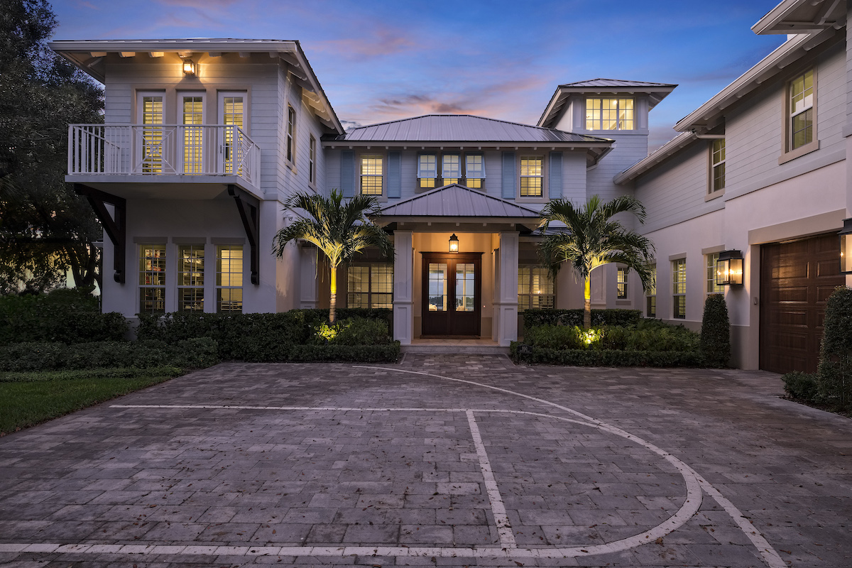 A stunning home with a basketball court in the front yard, offering both elegance and recreational opportunities.