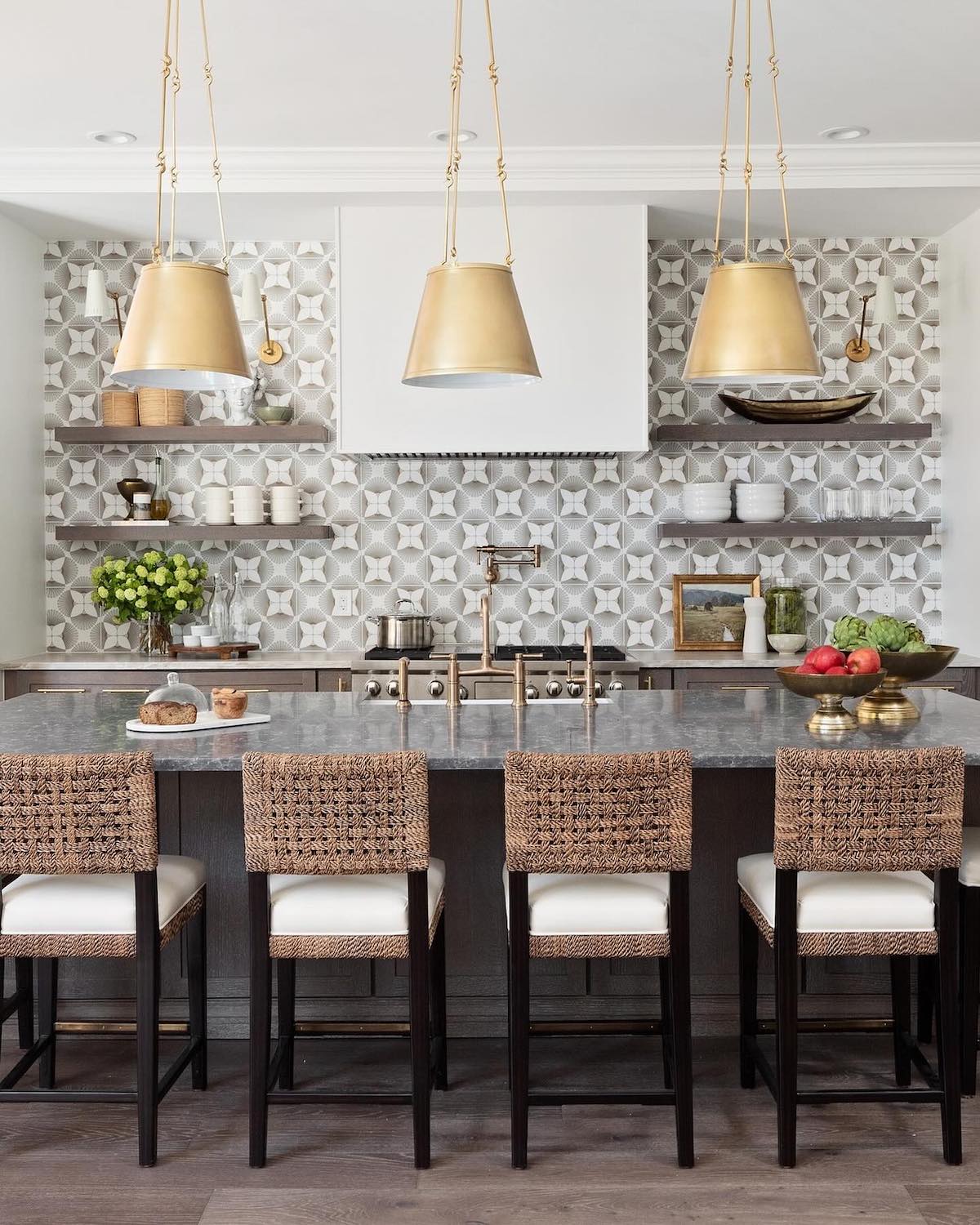 Modern kitchen with spacious island and elegant gold pendant lights.