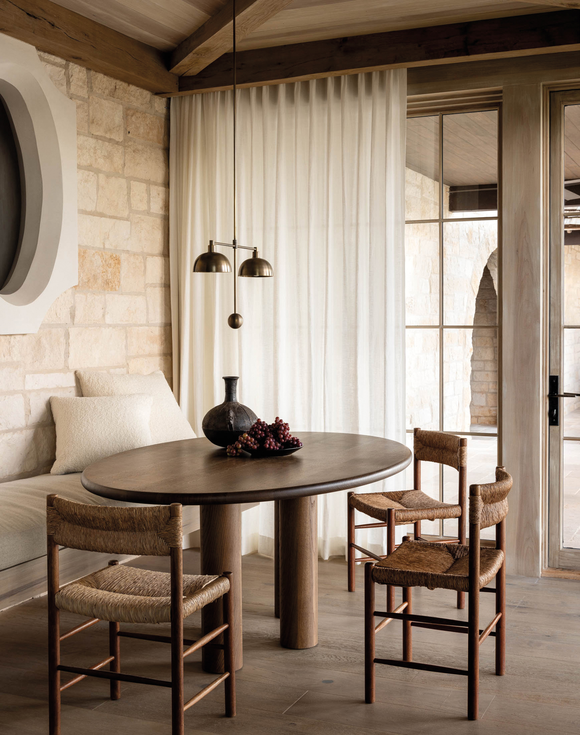 Breakfast nook with light wood floors and trim around floor-to-ceiling windows and doors
